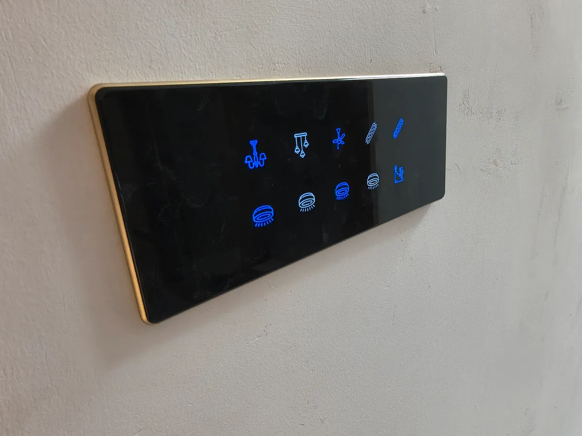 Backlit smart home control panel with blue zone icons, installed in a Bangalore home