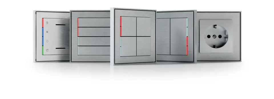 Ekinex 71 series FORM plates in grey and white with coloured LED status strips, next to a socket