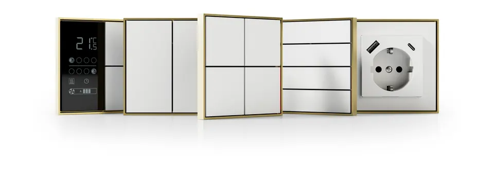 Ekinex FF series collection: white push-buttons, a room controller with display and a socket, each in a gold-tone frame