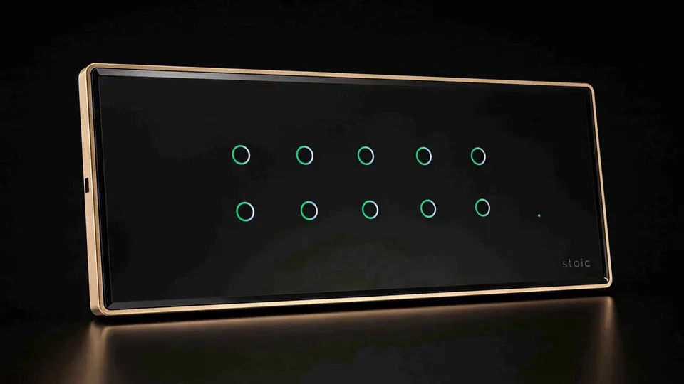 Illustrative render of a Stoic ZXC Zigbee Edge touch panel in black glass with green ring indicators and a gold frame